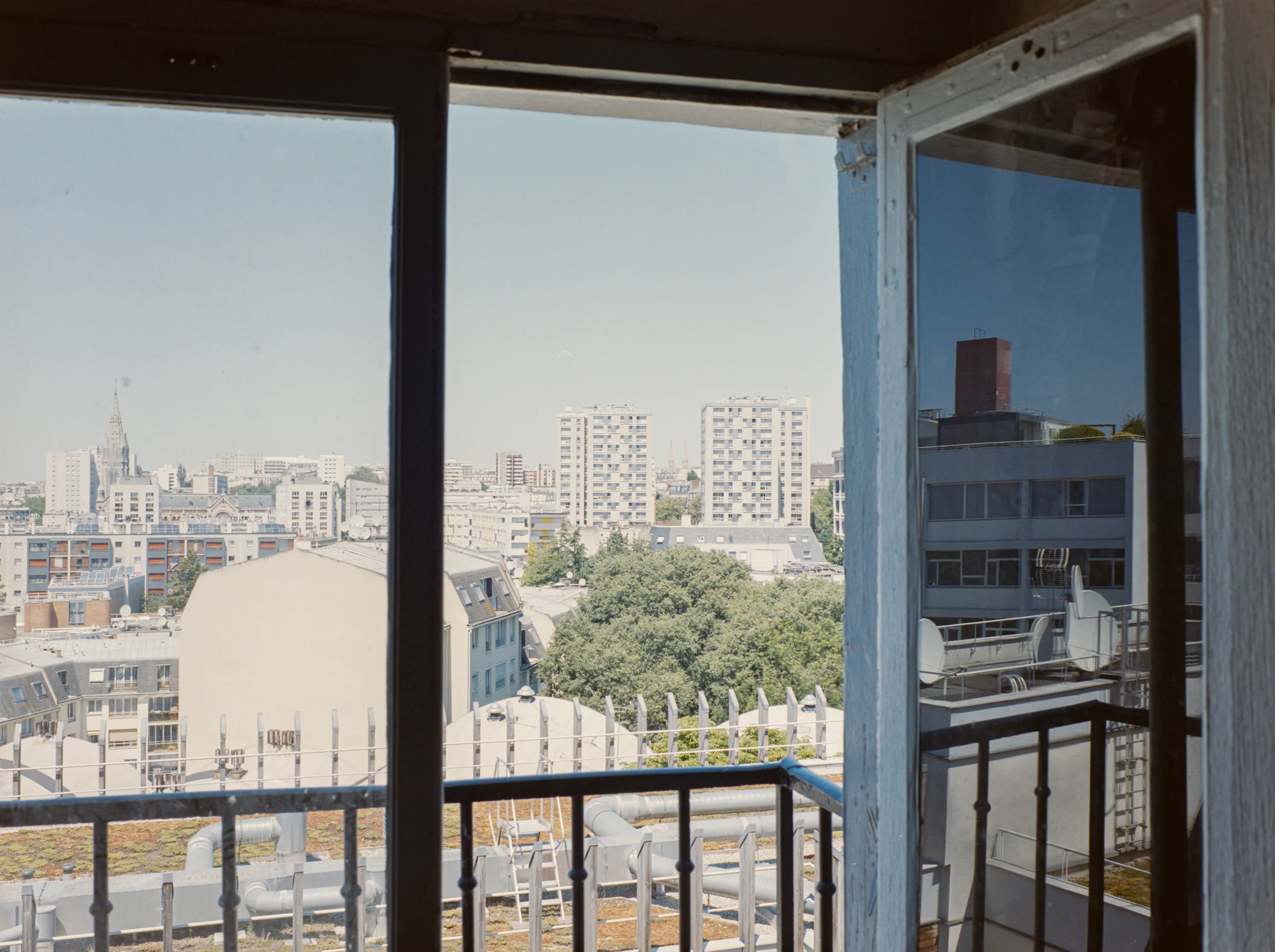 View of the city through an open balcony door