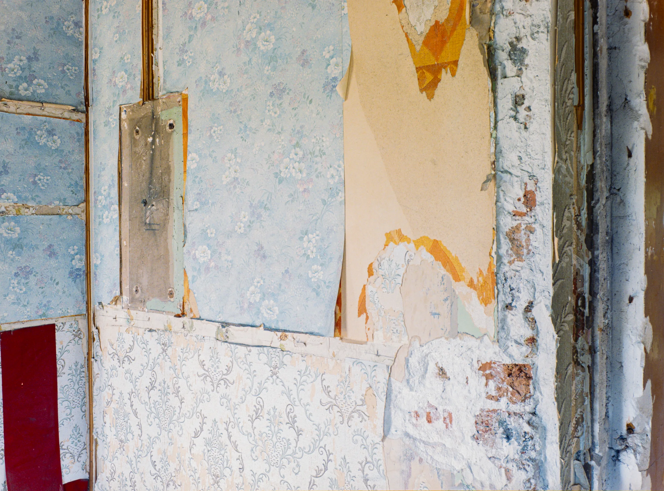 Close view of layered wall finishes around a doorway